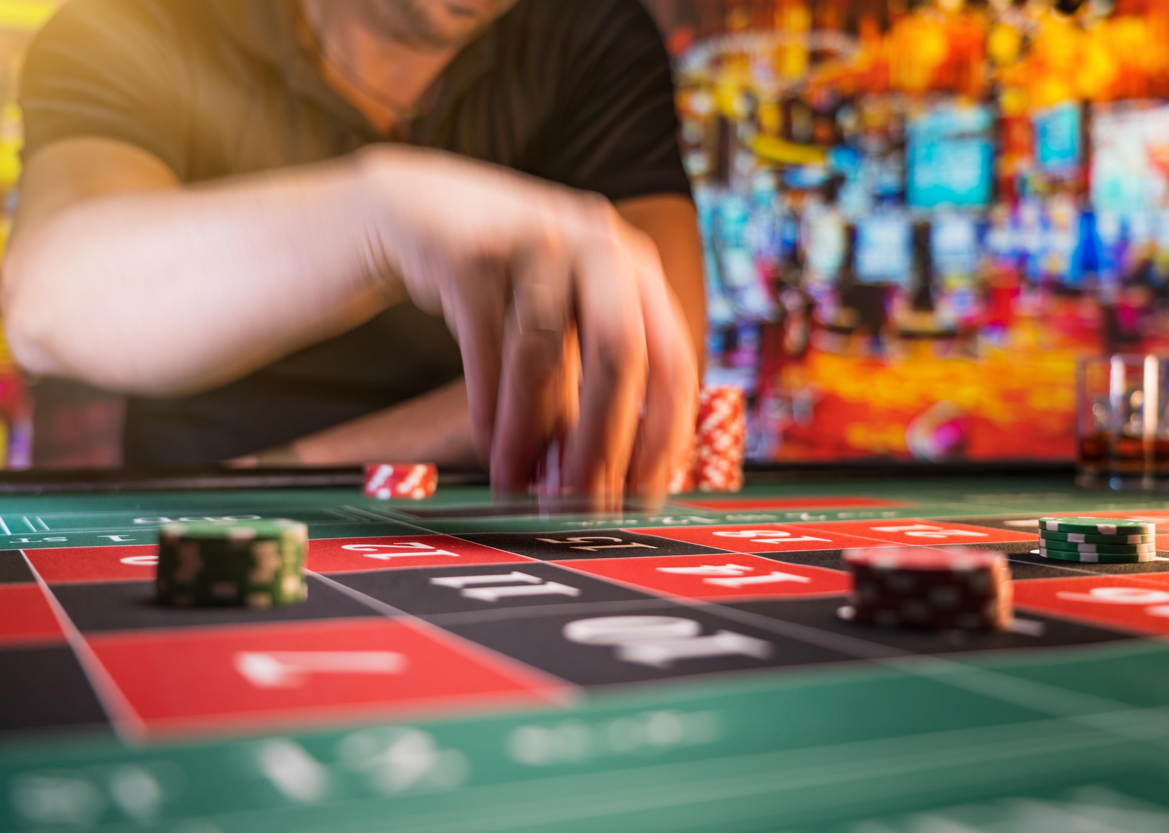 Man playing roulette at the casino.