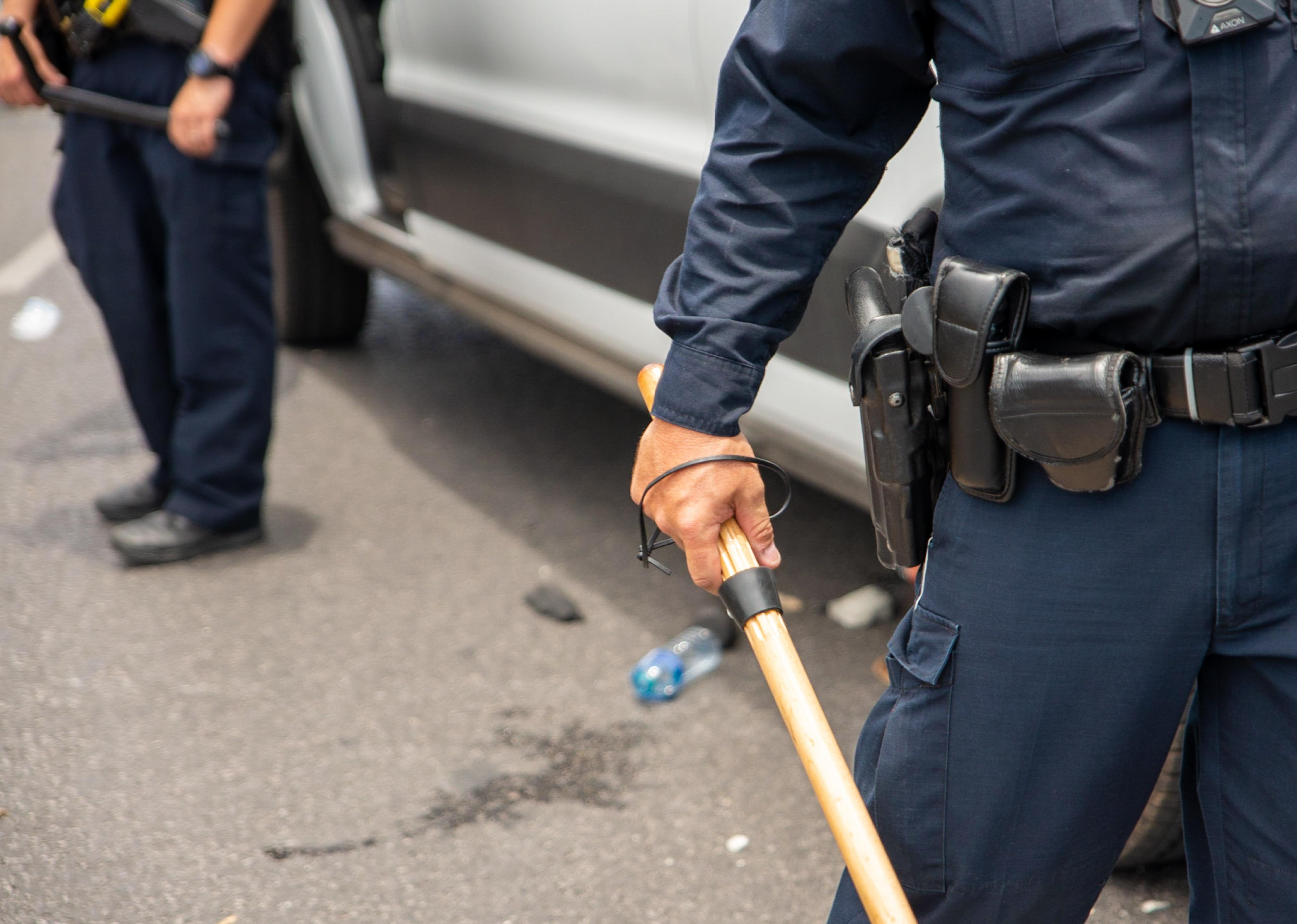 A police officer watches protesters.