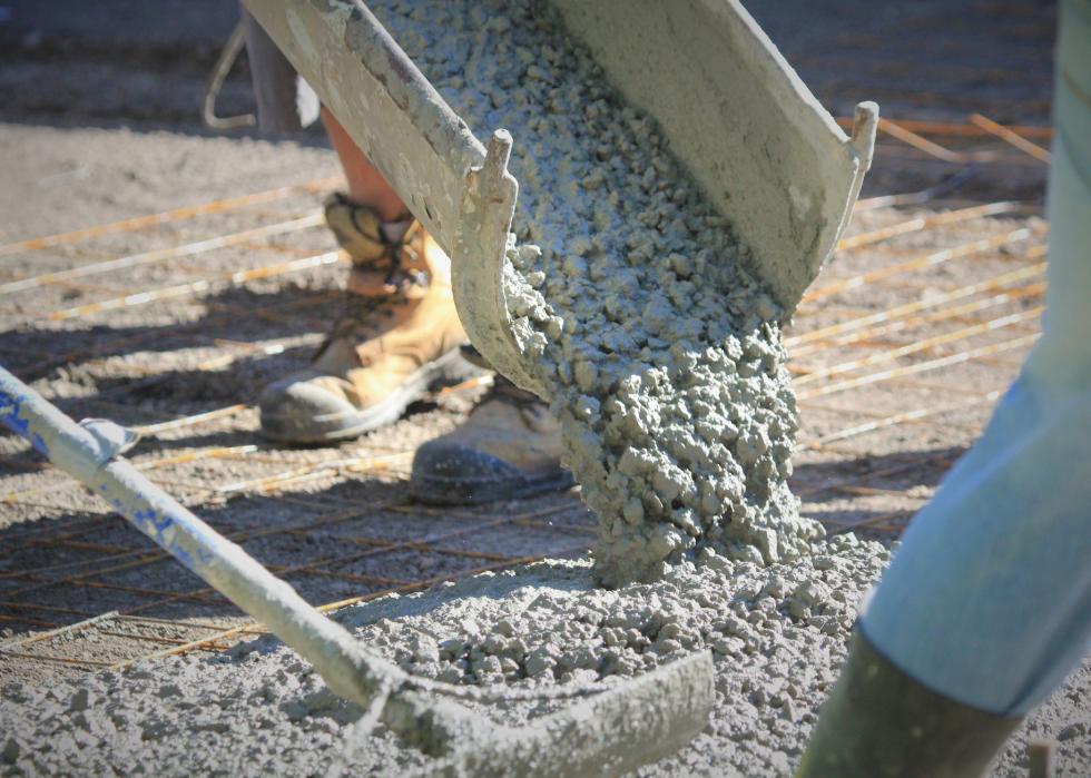 Concrete being poured onto a driveway.