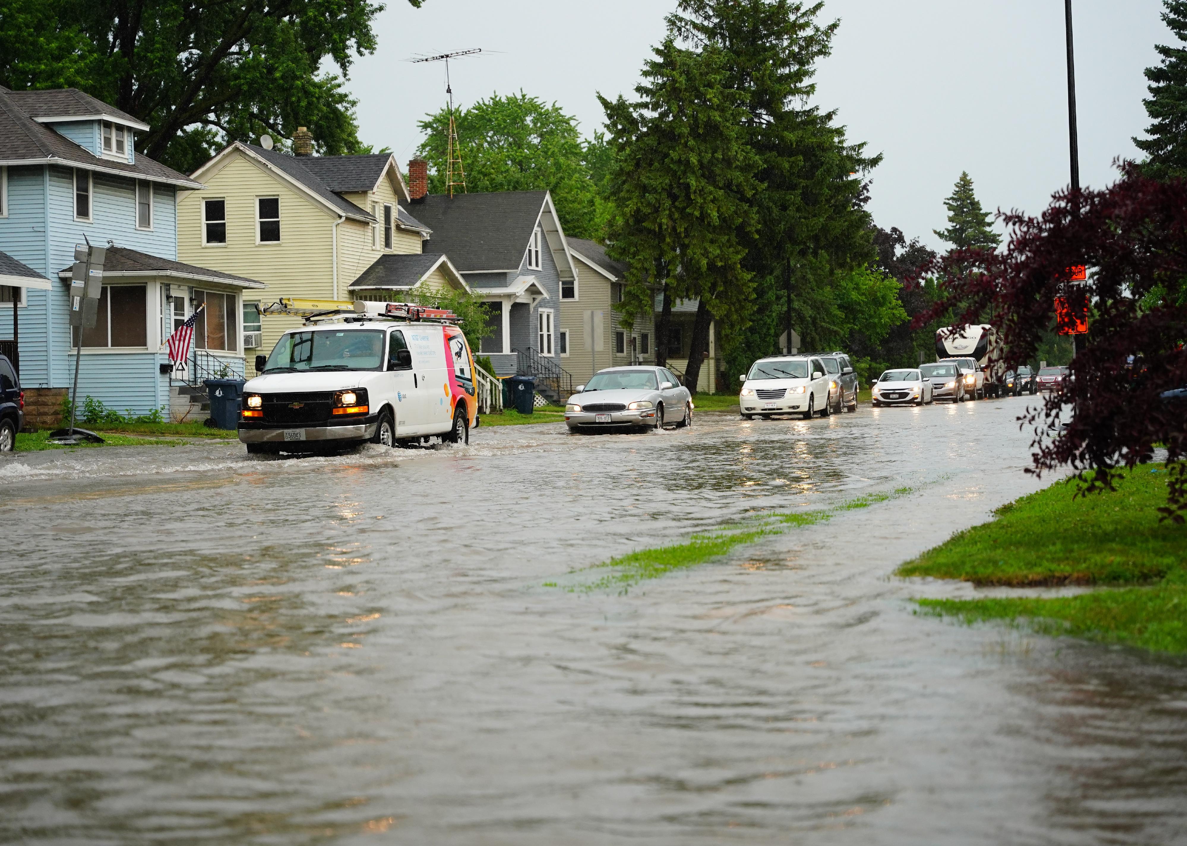 Citizens of Fond du Lac drive through the flooded streets.