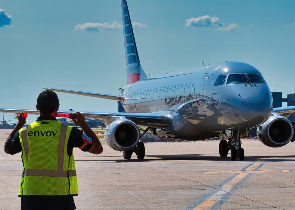 Envoy ramp workers bringing the aircraft to the gate