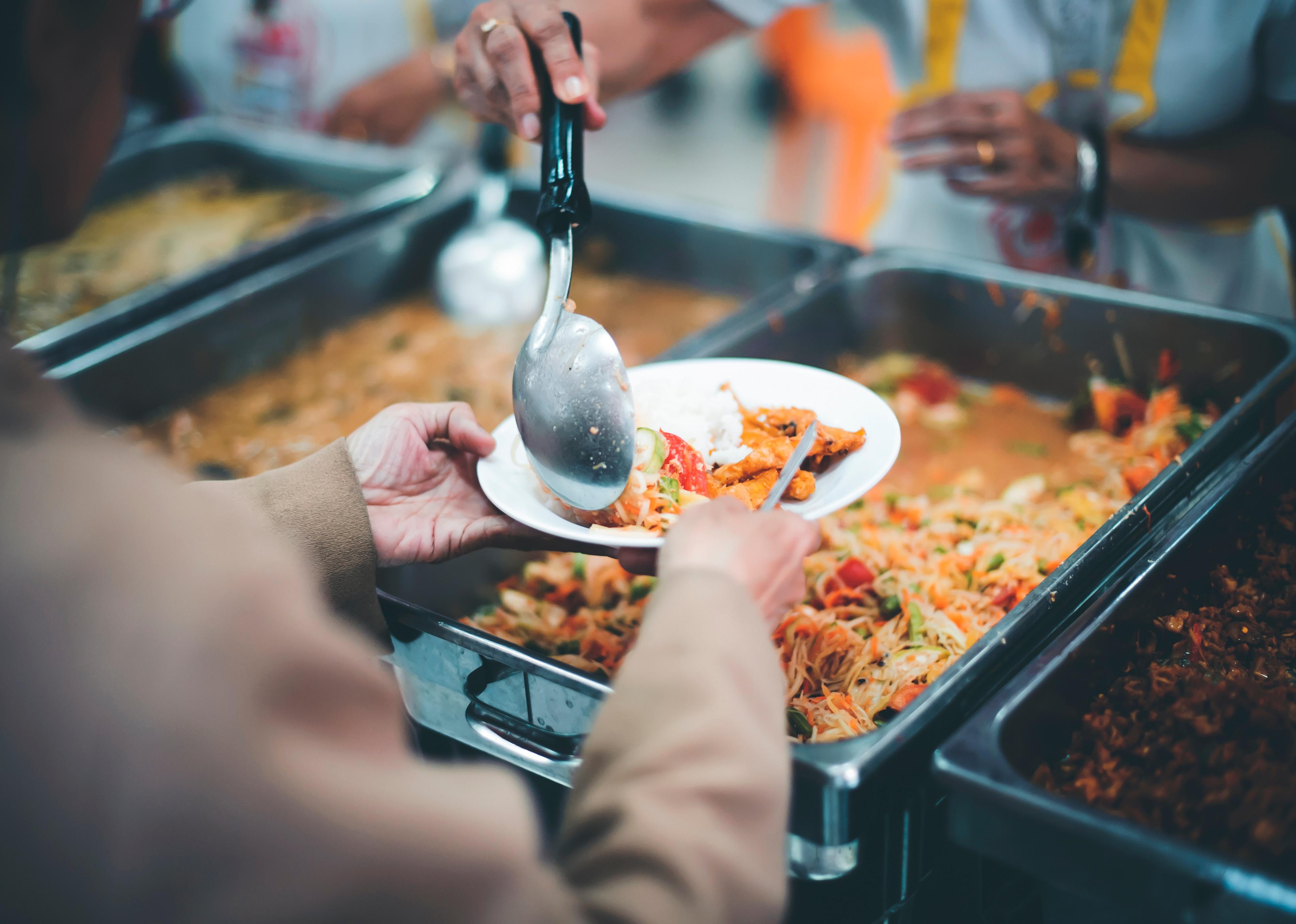 Volunteer handing out shelter meal.