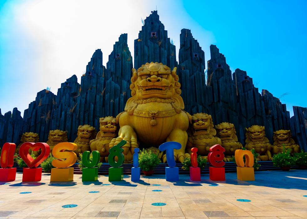 A large statue of a guardian dog at Suoi Tien park.