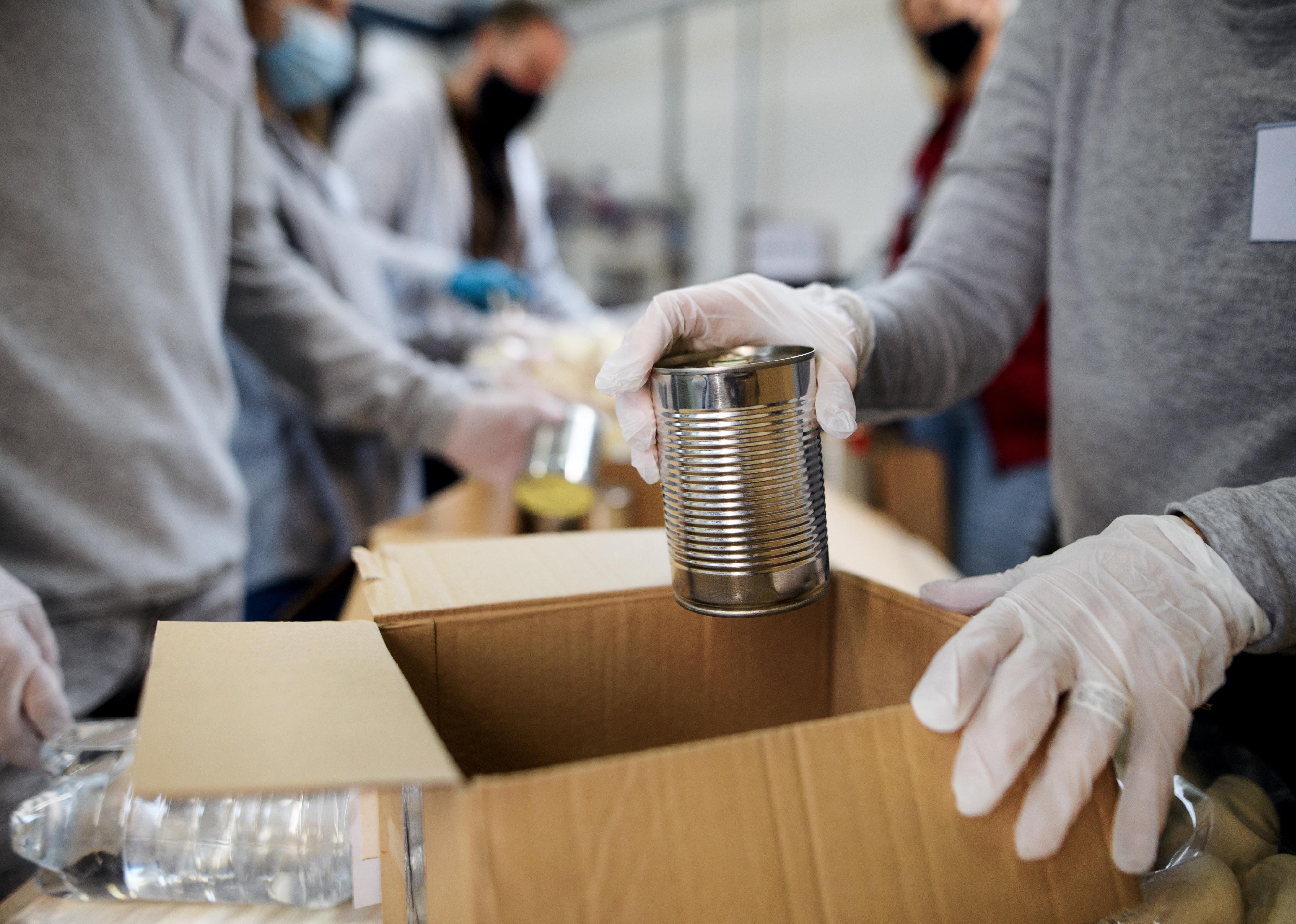 Midsection of group of volunteers in community donation center.