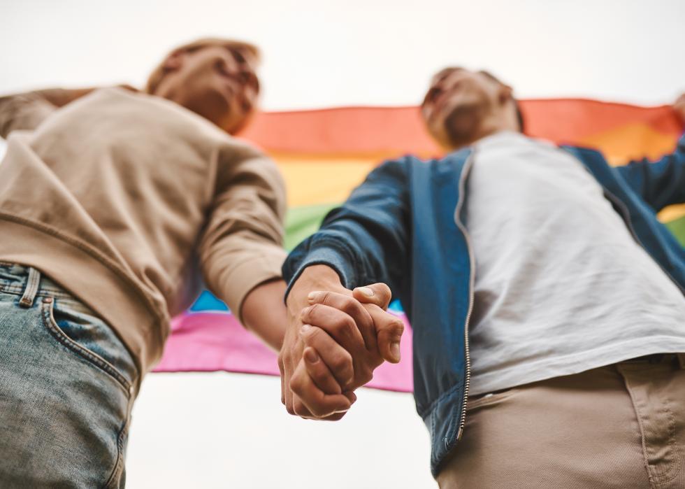 Close up of two men holding hands