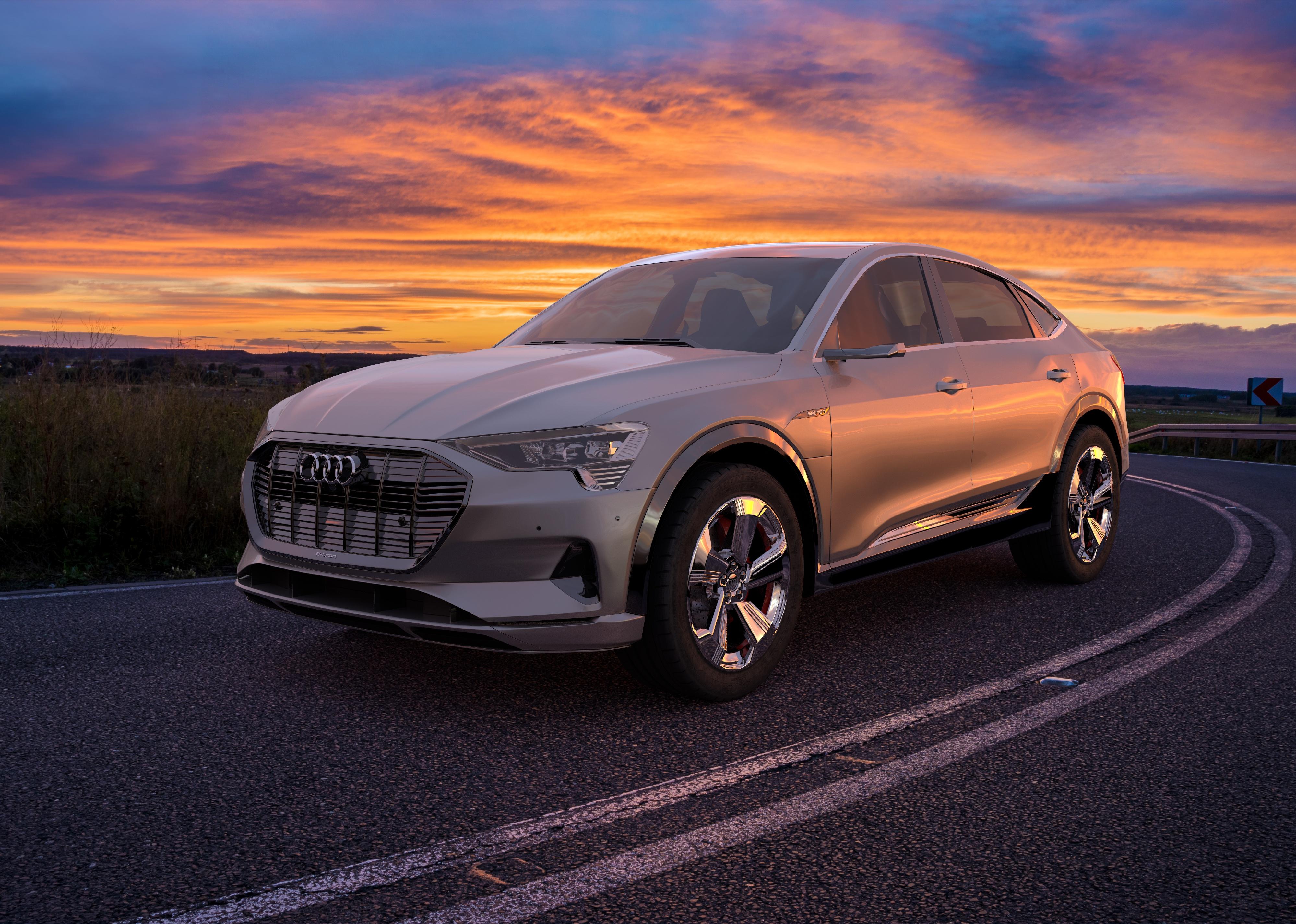 Audi e-tron Sportback on the road with a sunset.