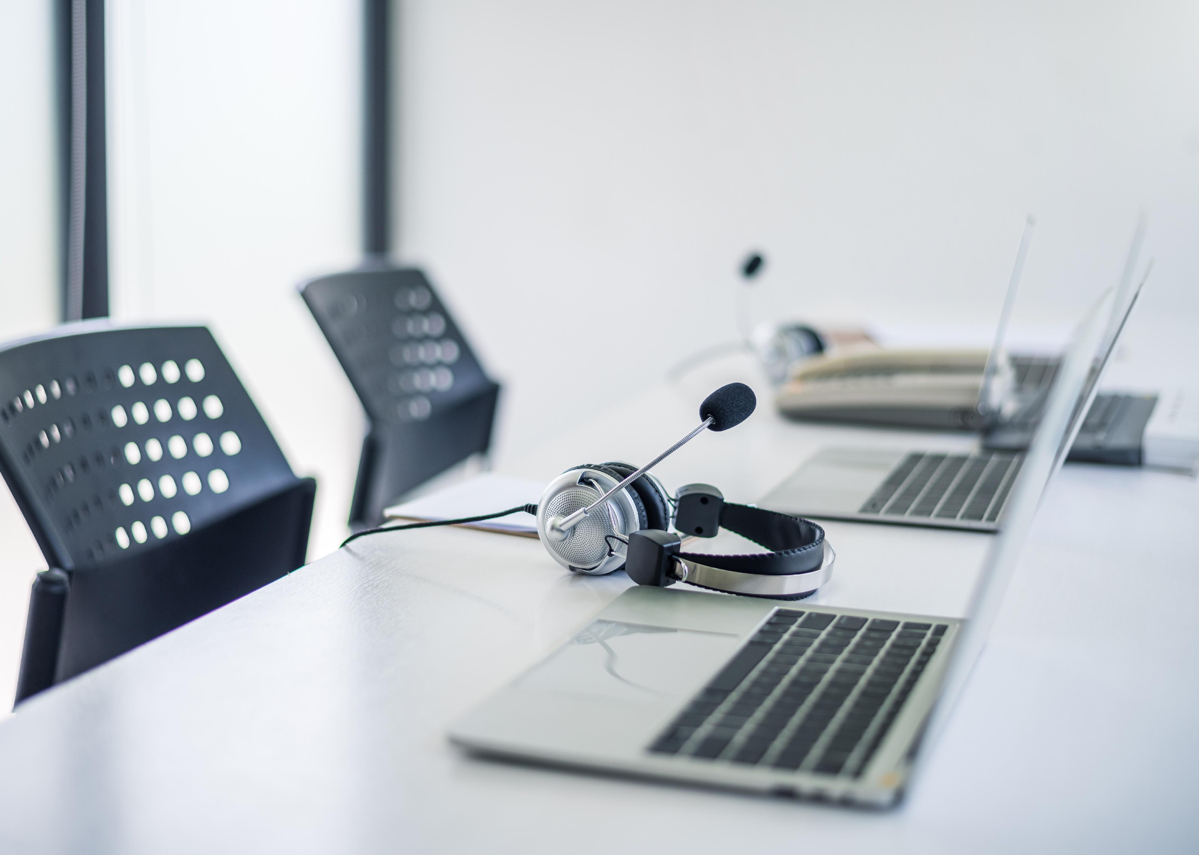 Call center equipment on a table at a office.