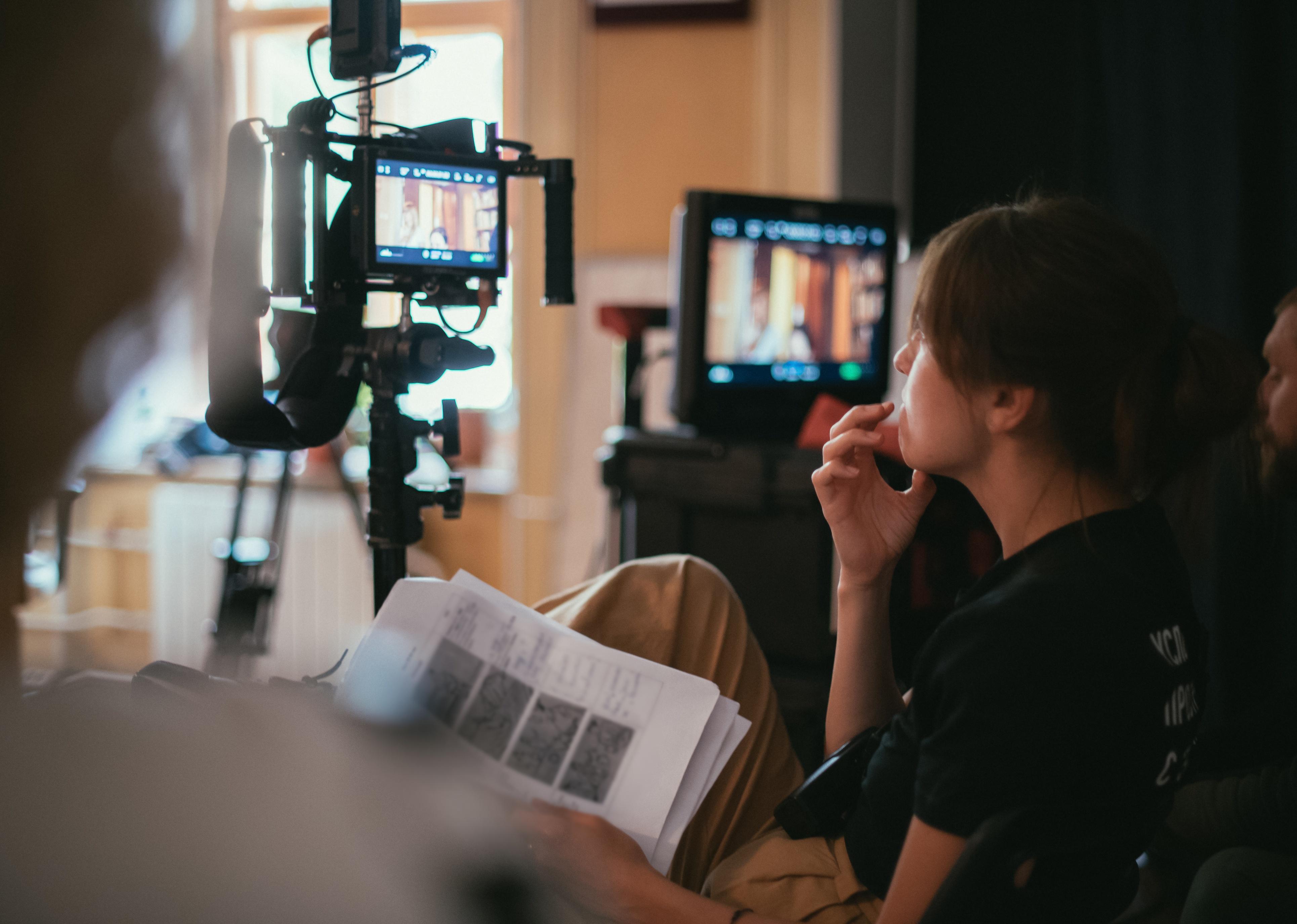 The director works with a playback while filming a movie.