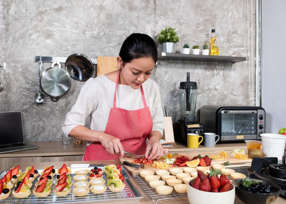 Asian woman making fruit tart for an online sale