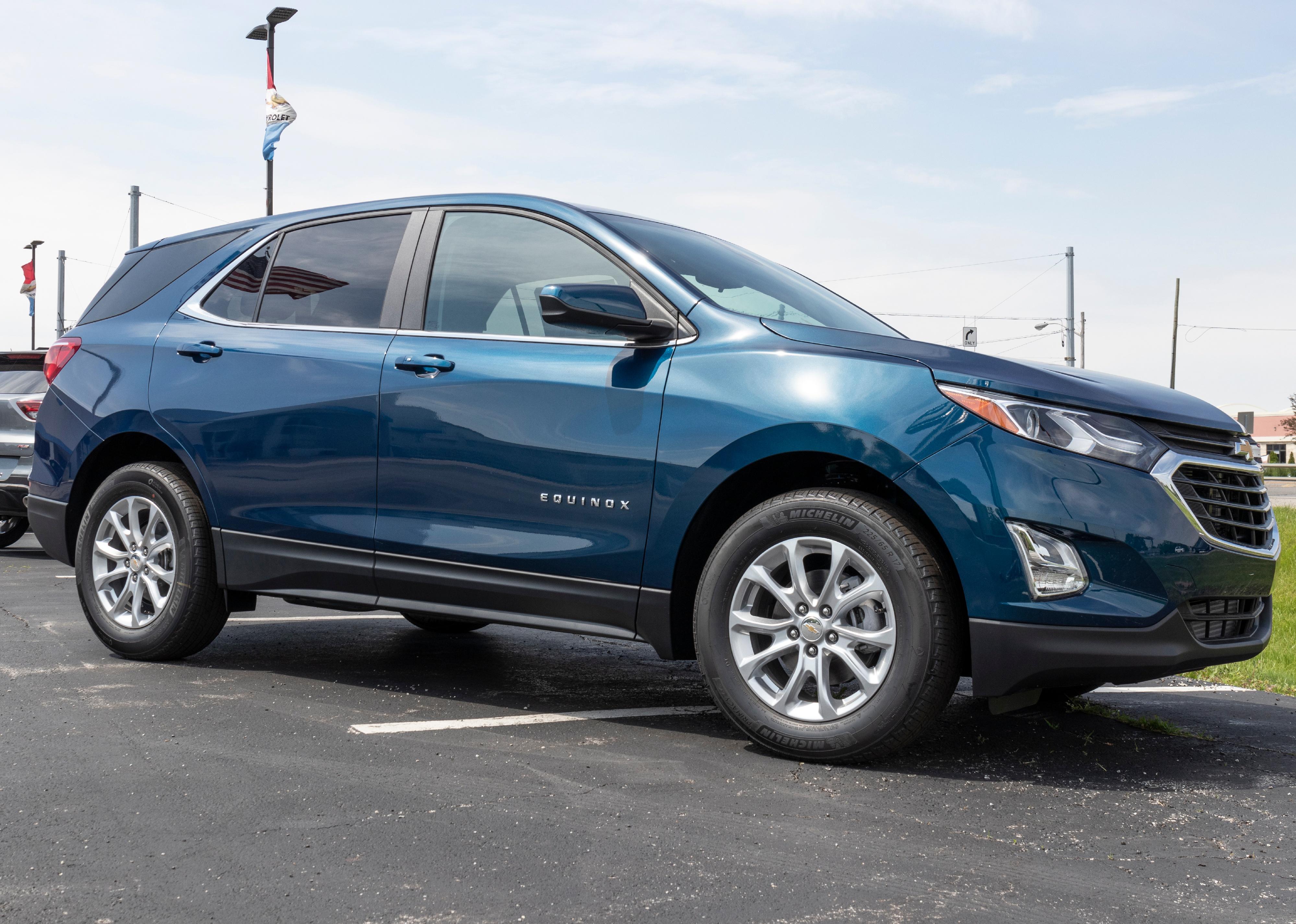 Blue Chevrolet Equinox SUV on display outside.