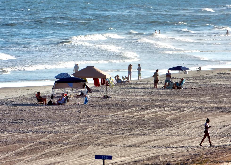 Close up on beach goers and their setups.
