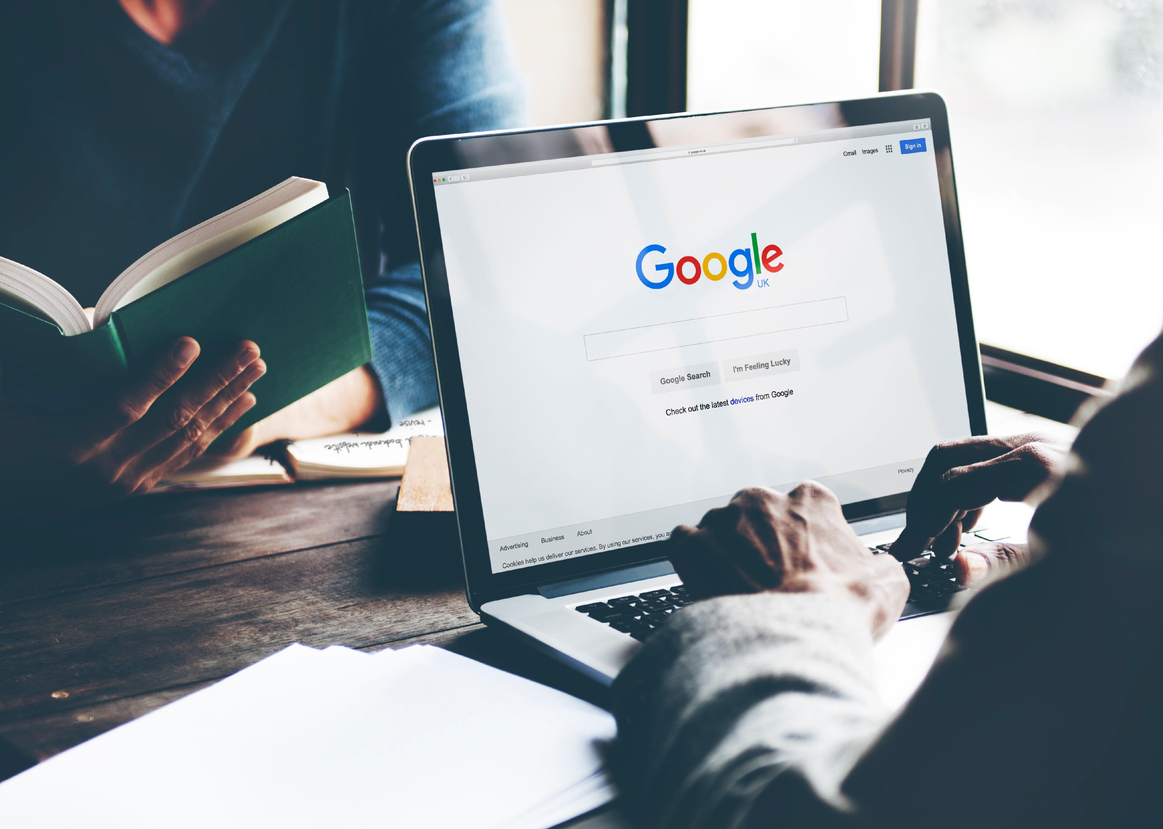 Man using laptop and browsing Google.