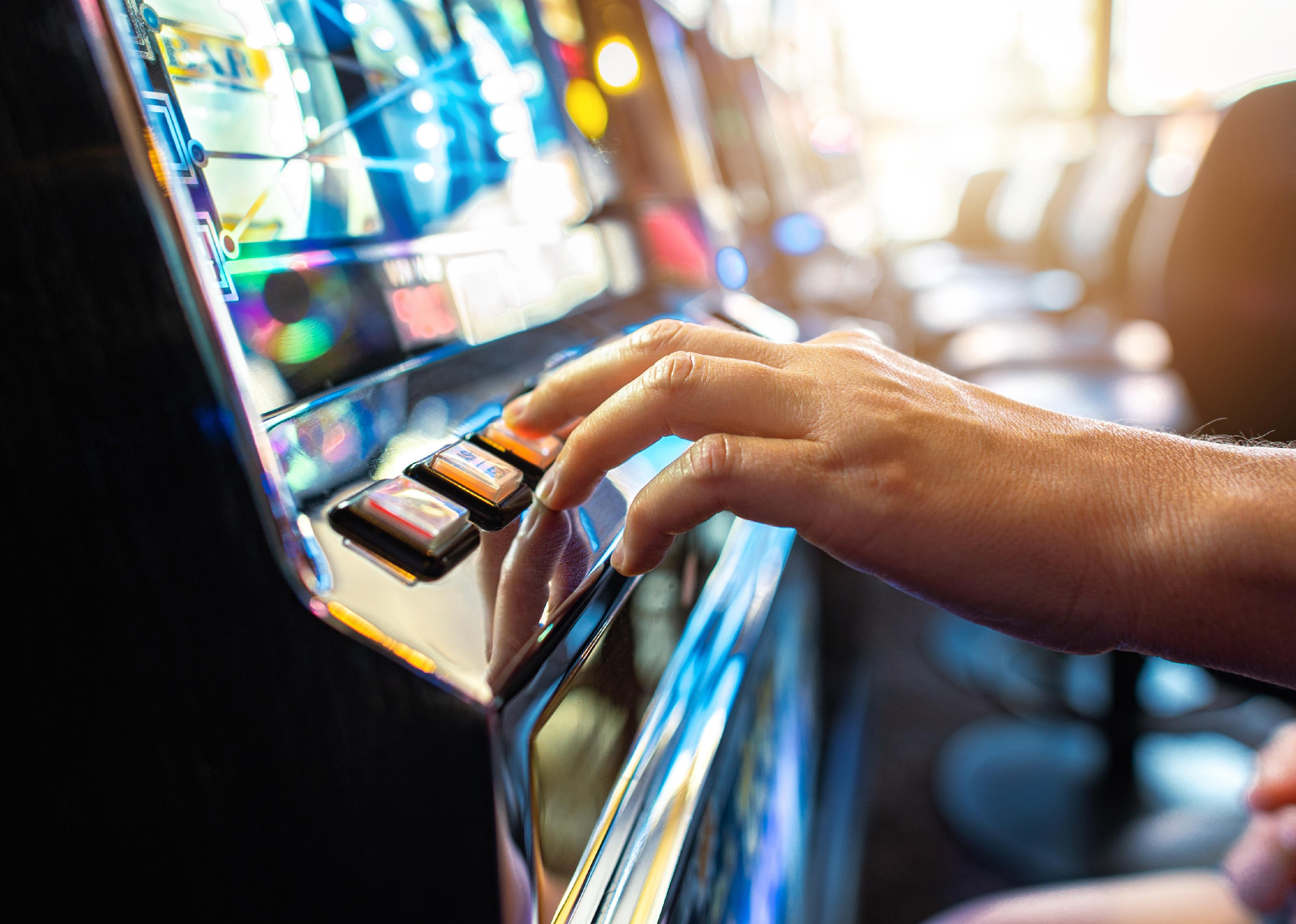 Person playing classic slot machine.