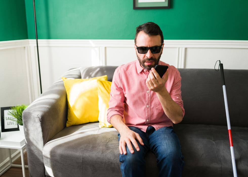 Blind man using the voice assistant on his phone