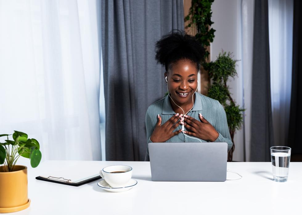 Woman on video call behind laptop