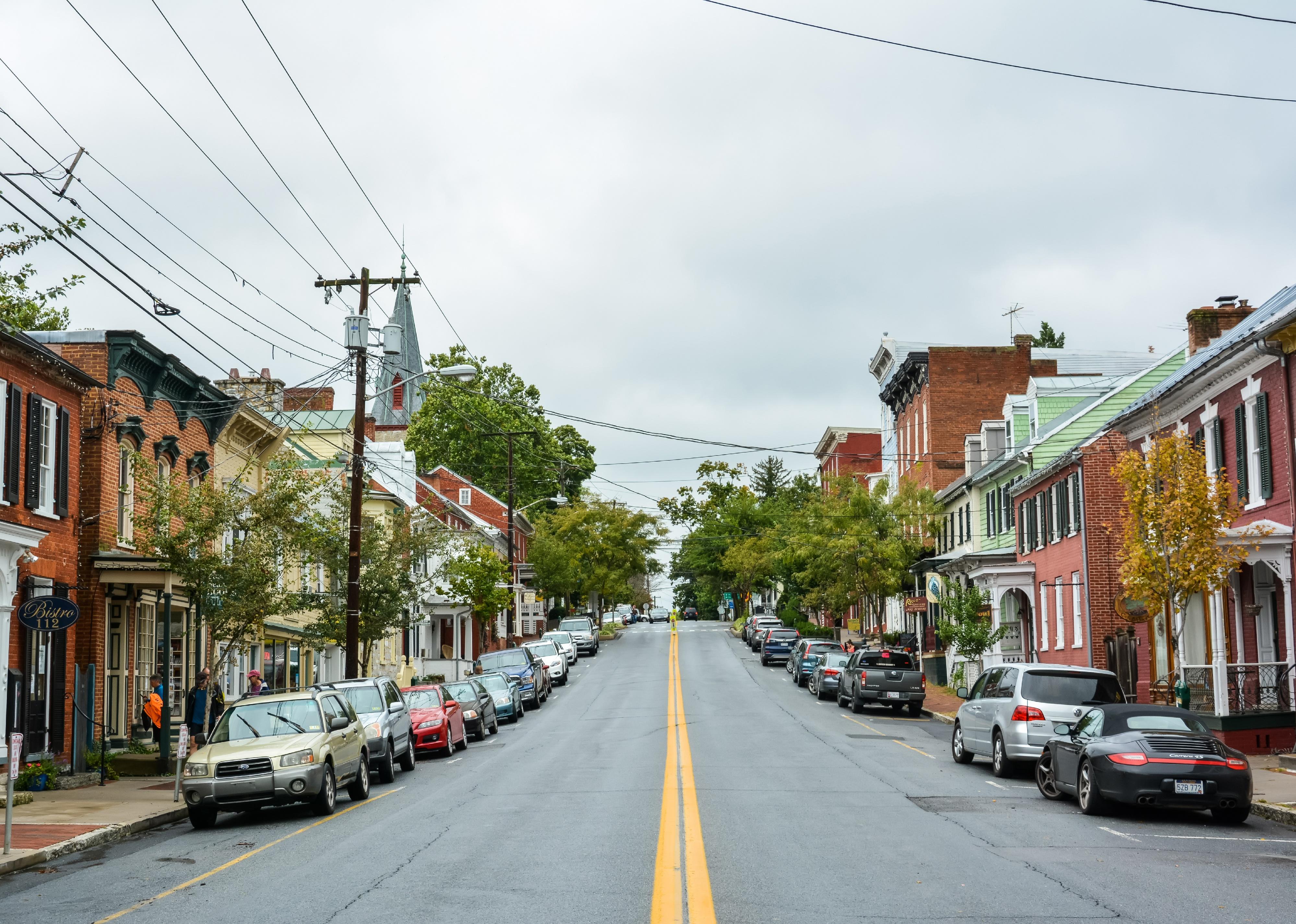 View with cars and people on a cloudy day.