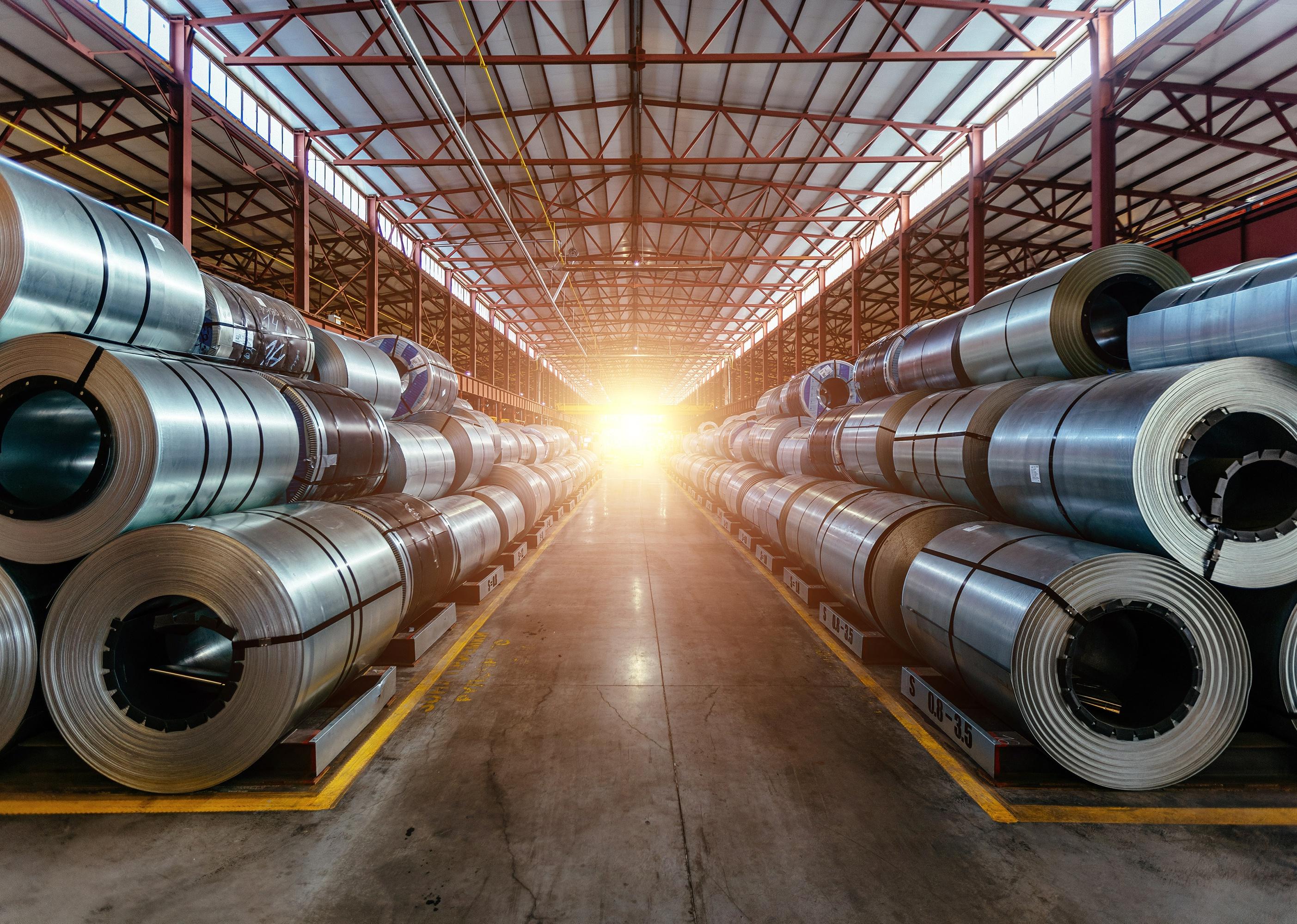 Rolls of galvanized steel sheet inside the factory or warehouse.