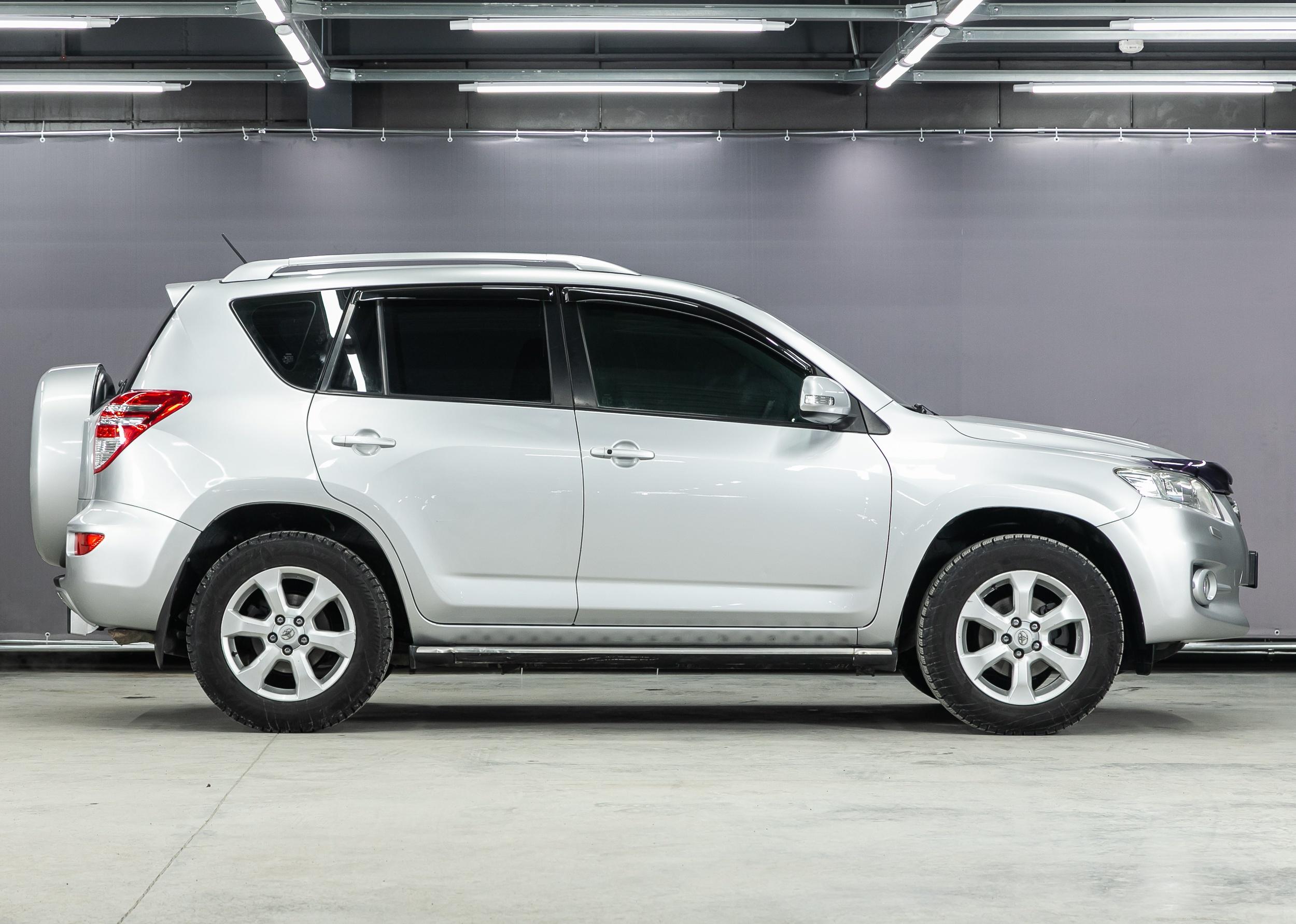 Silver Toyota RAV-4, side view.