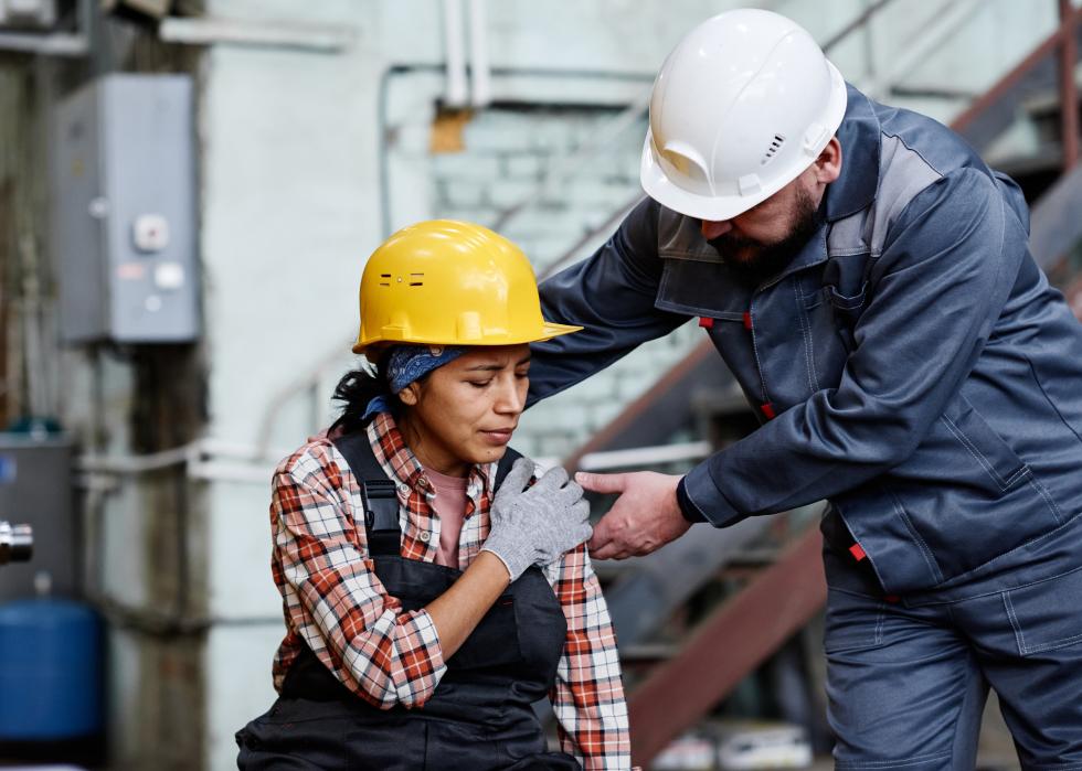 Foreman standing by female engineer with contusion