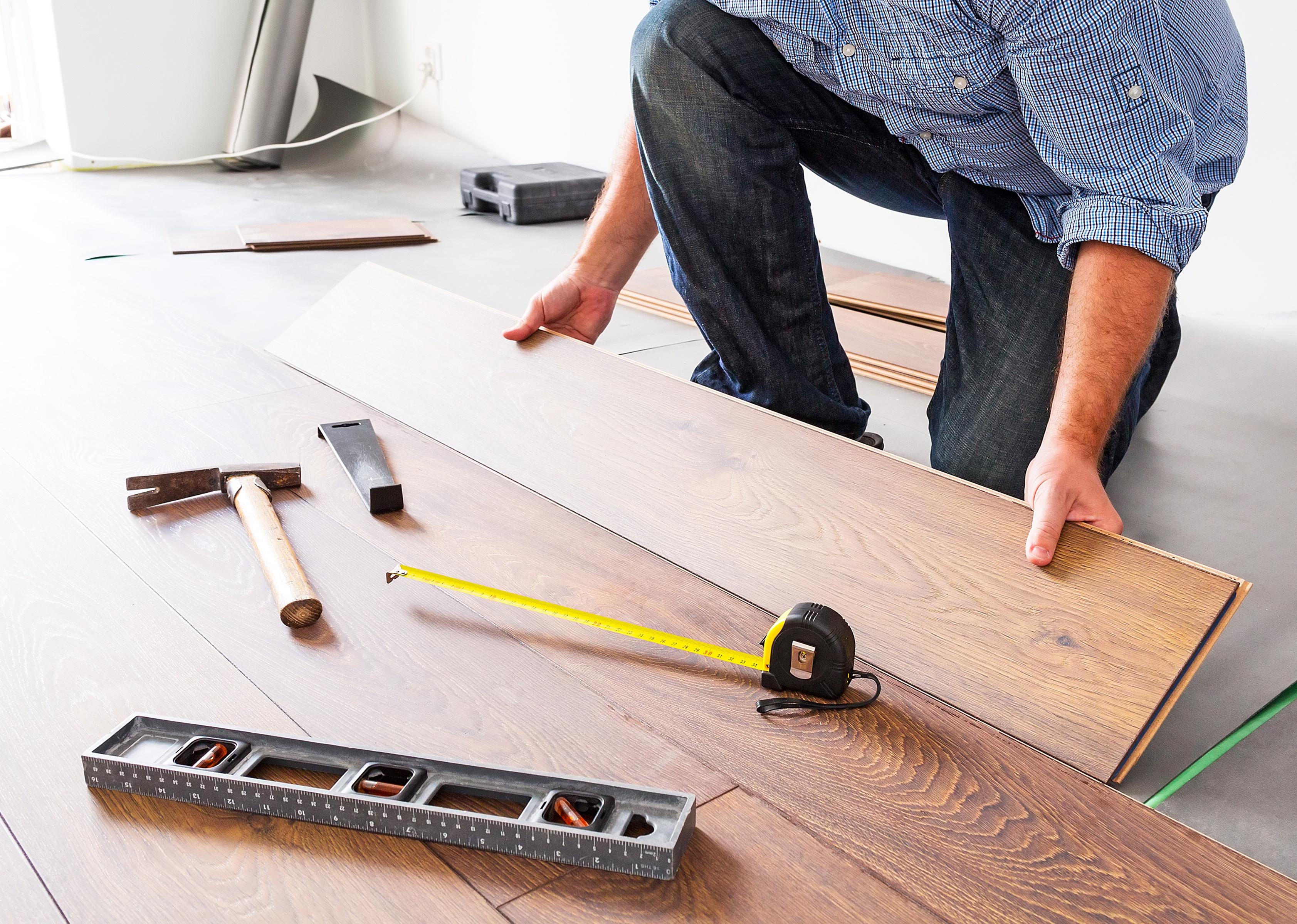 Man installing new laminated wooden floor