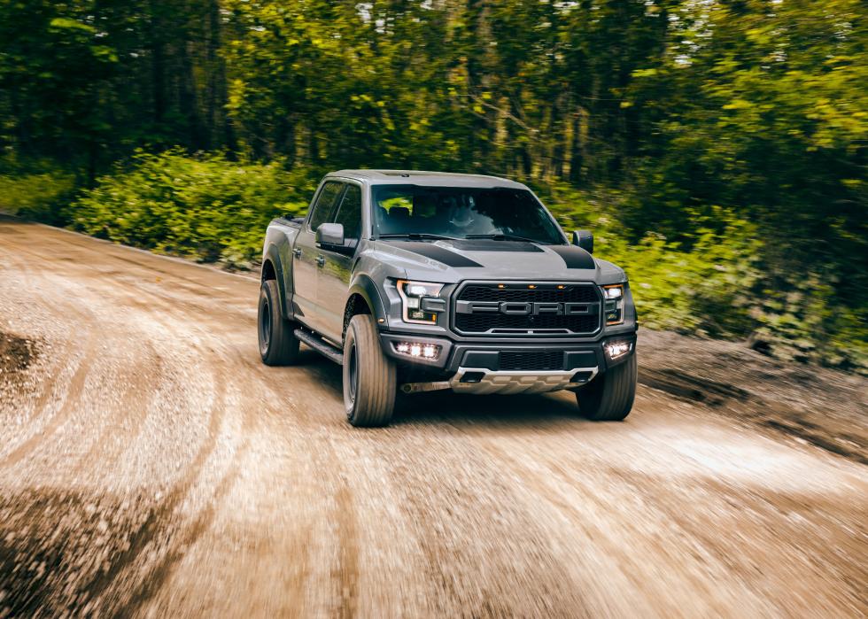 Ford Raptor driving on dirt backroads.