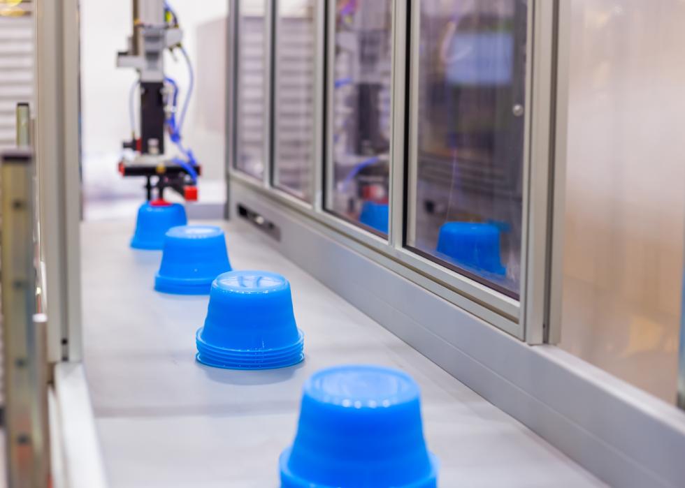 Blue polypropylene cups on conveyor belt
