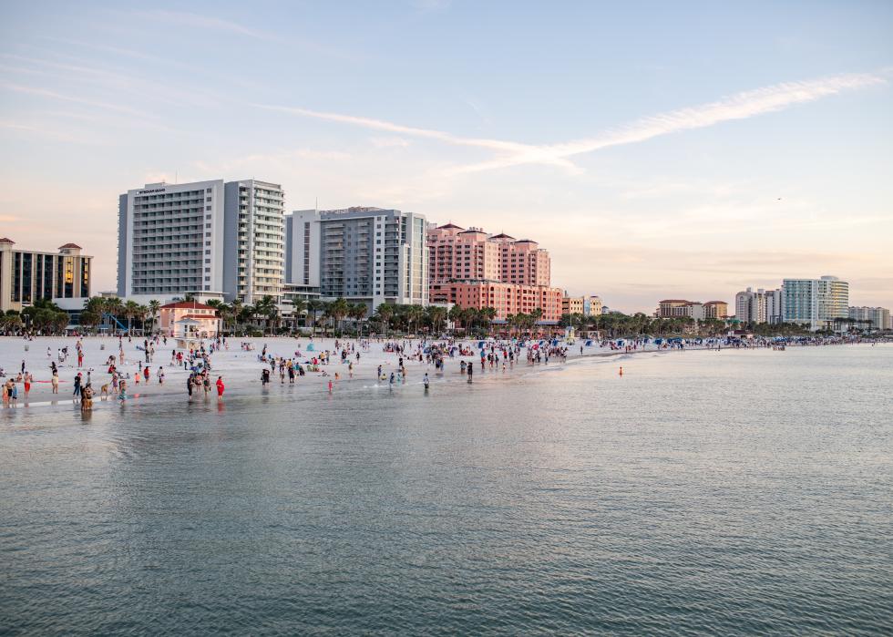 Coastline with beach goers and buildings.