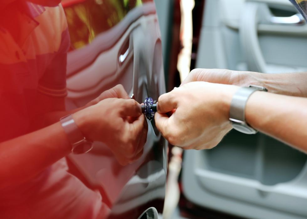 Person fixing car dent by himself.