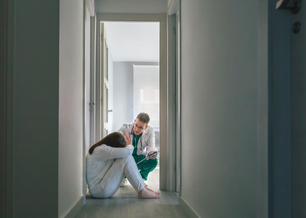 Doctor trying to help woman patient in the hospital.