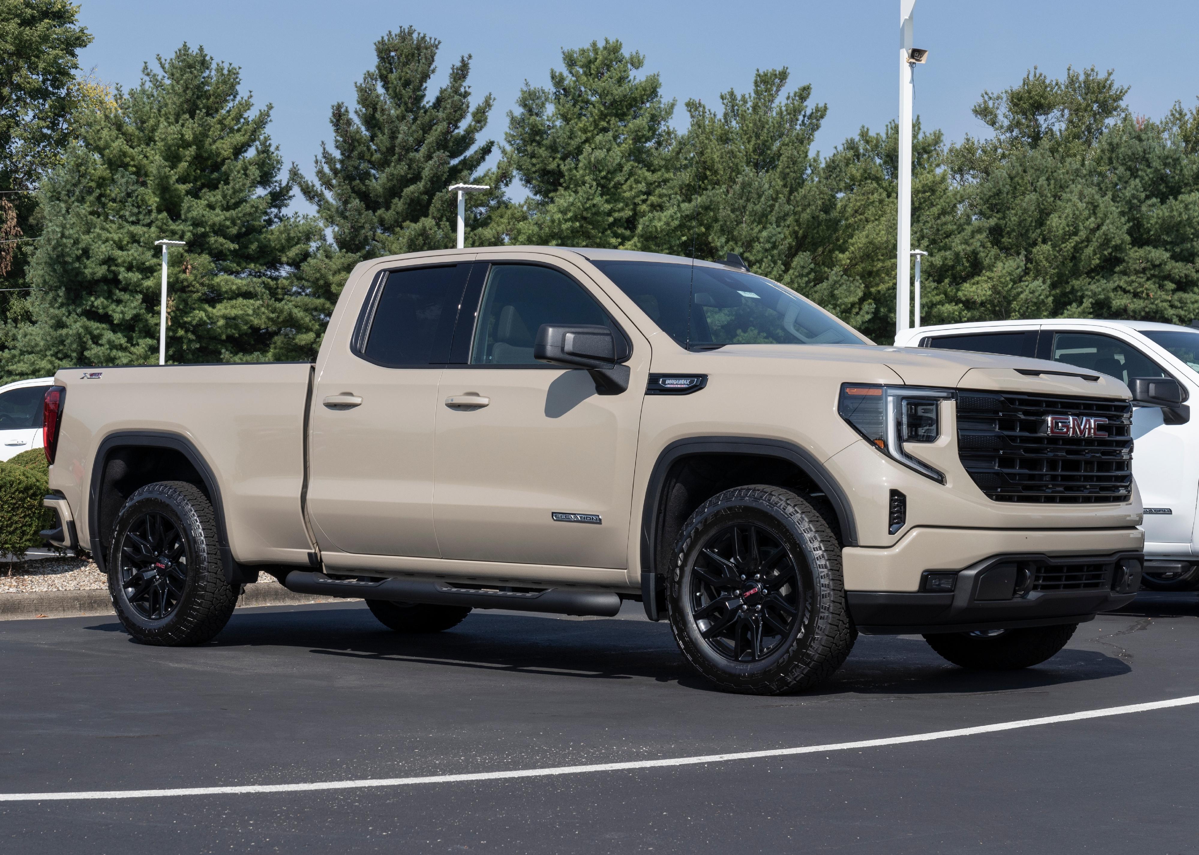 Beige GMC Sierra 1500 Elevation in parking lot.