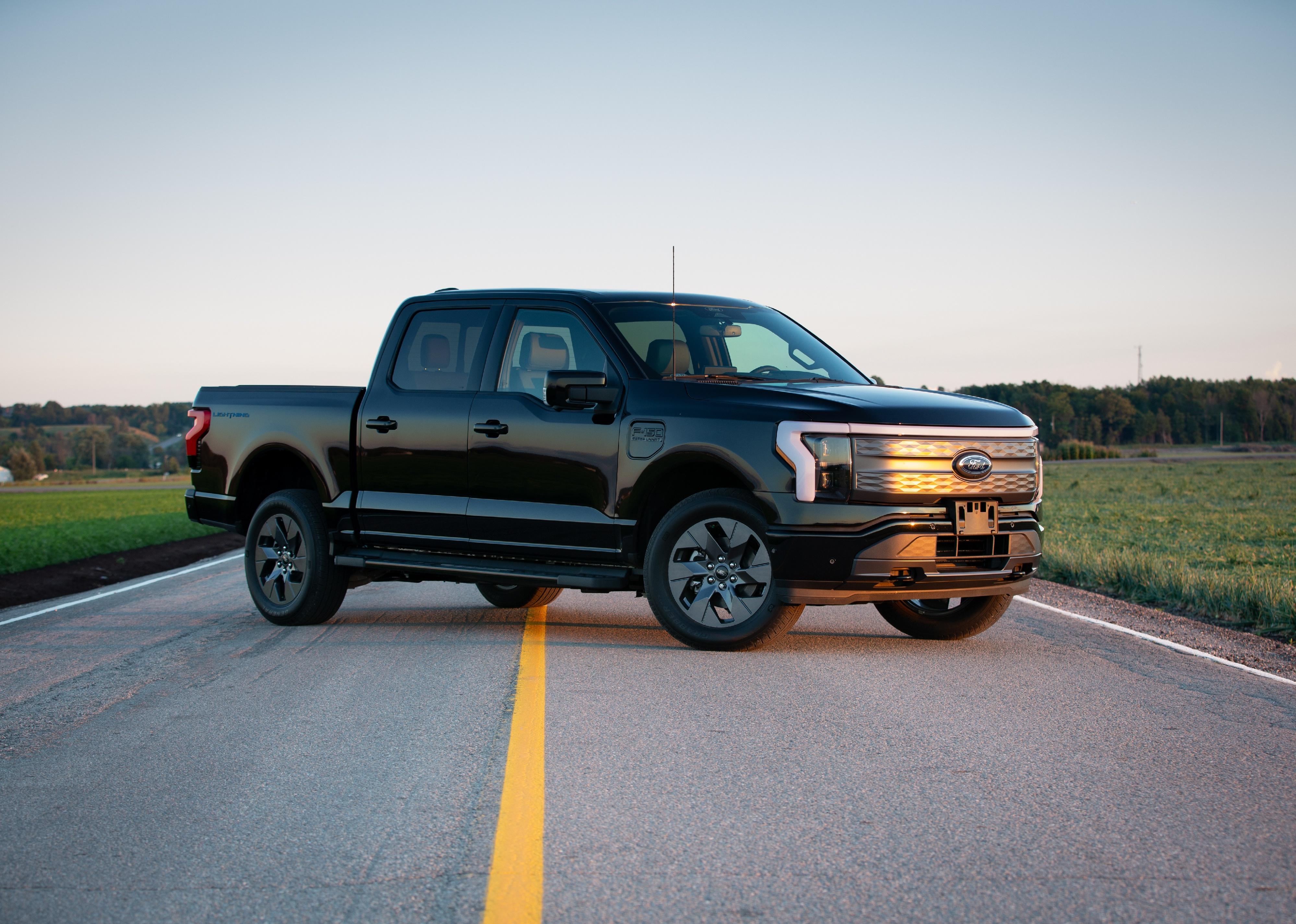 Ford F150 standing sideways on an asphalt road.