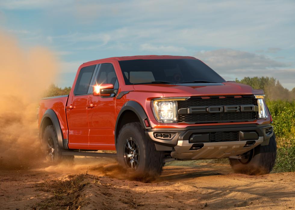 F-150 Raptor driving through dirt.