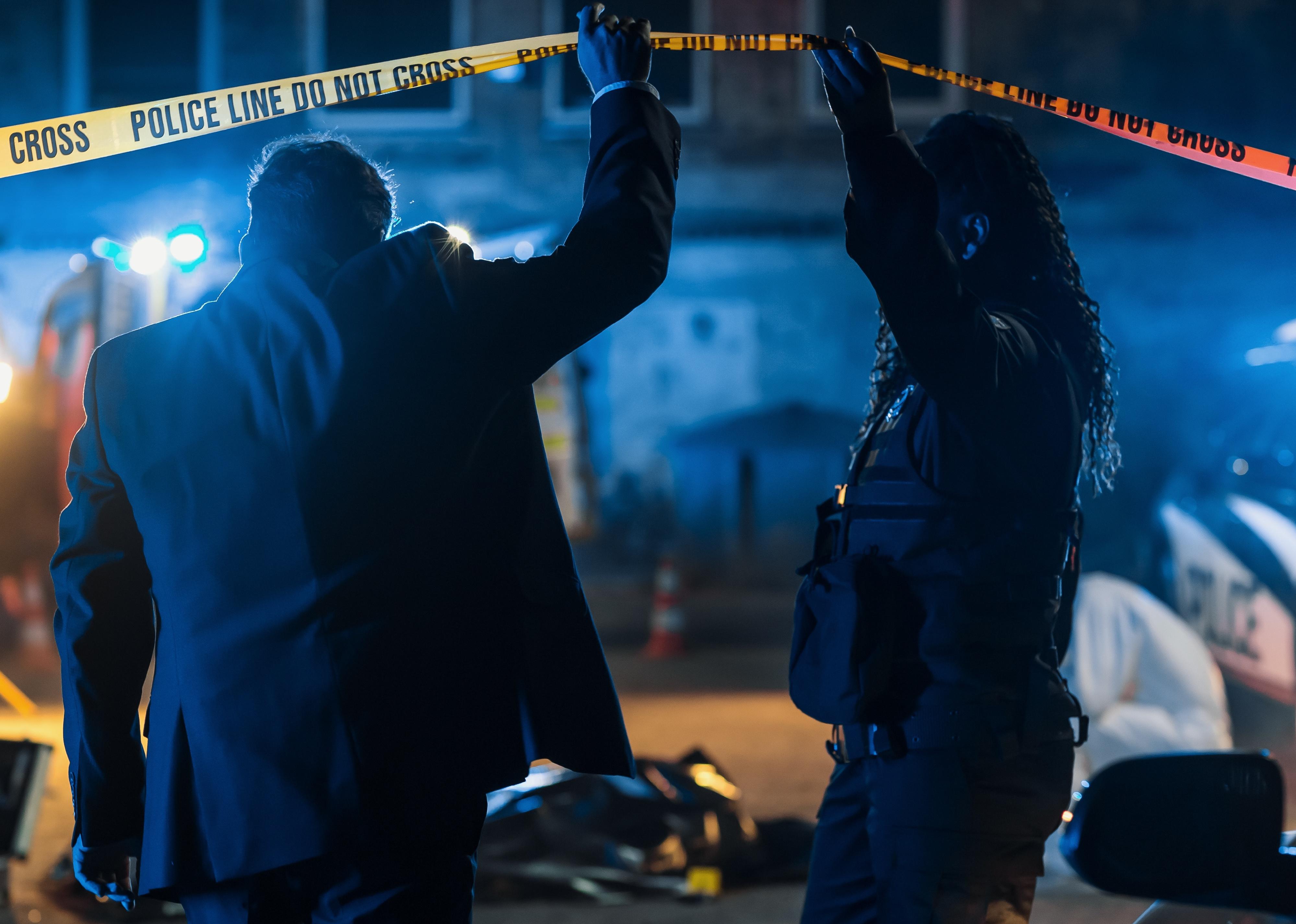 Two officers on site of crime scene.
