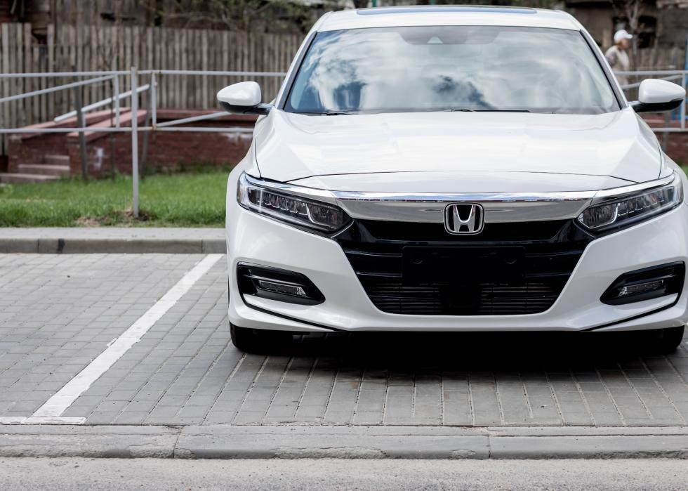 A white Honda Accord parked in a parking space.