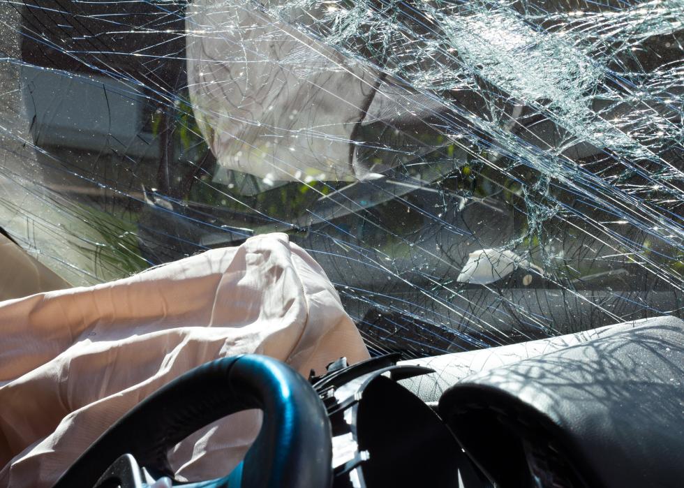 Inside a car, sunny, with airbags and windshield cracks