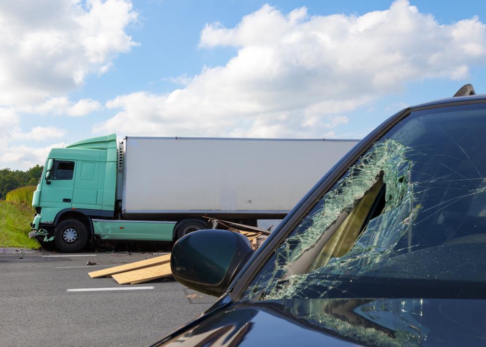 View of car after an accident with large truck in background
