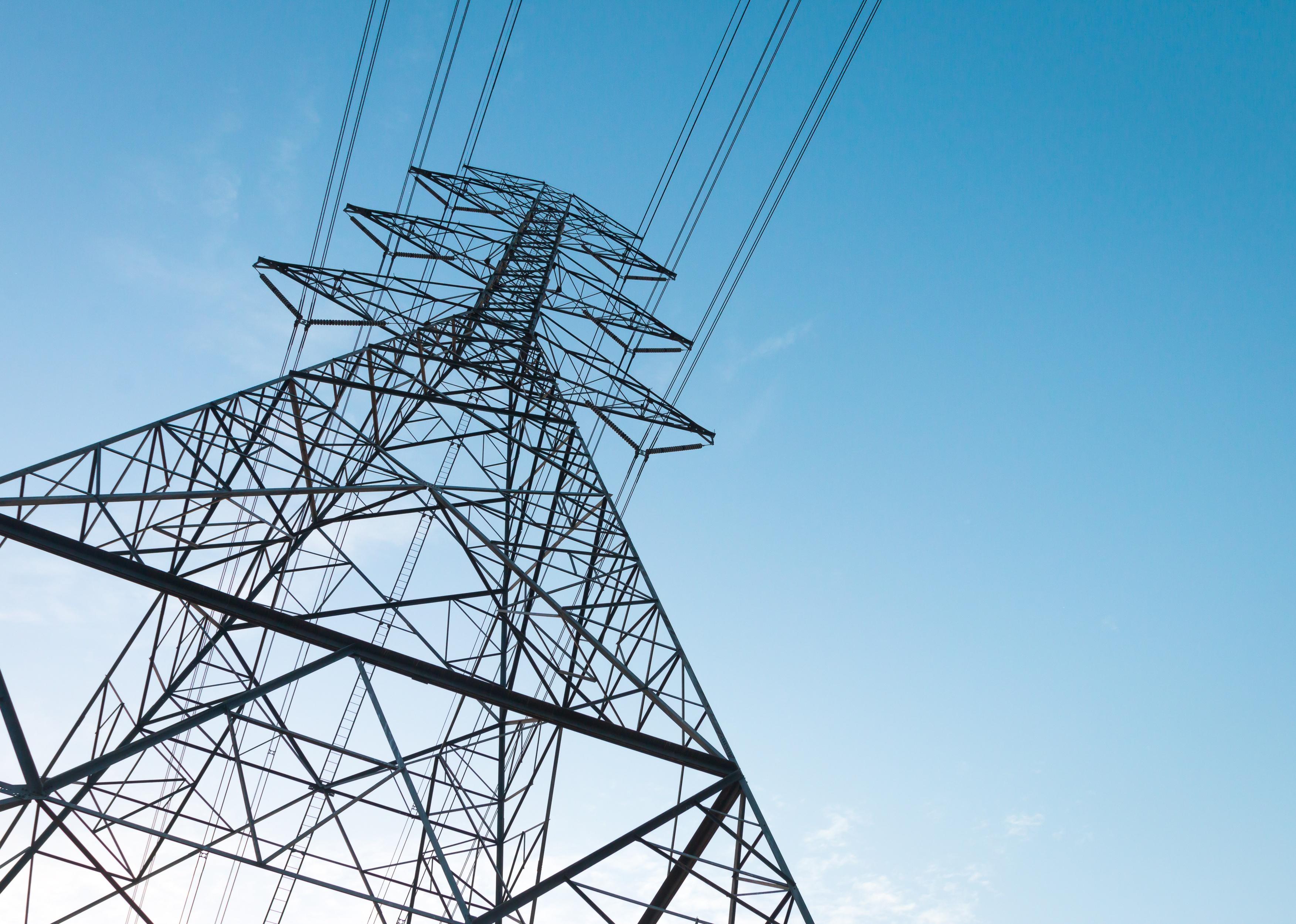 Electricity transmission power lines at sunset.