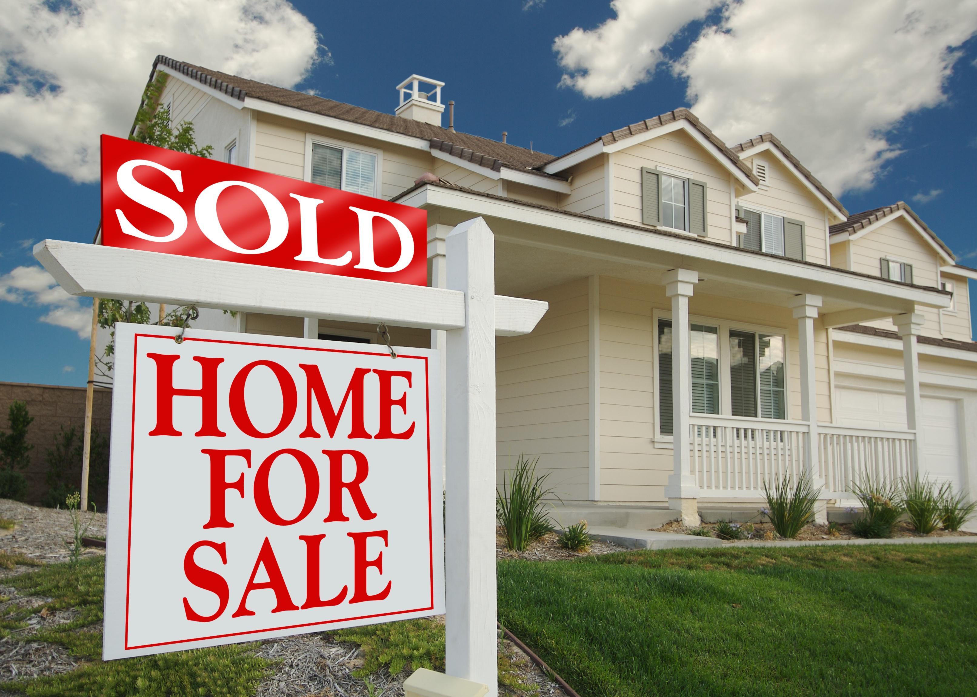 For Sale sign in front of a home.