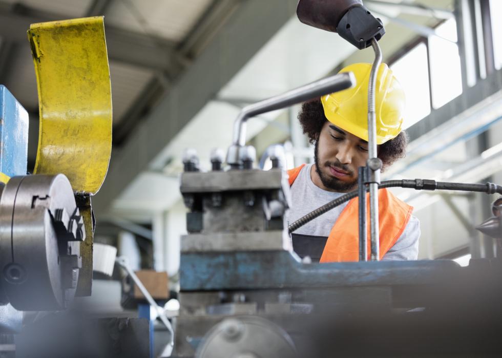 Low angle view of machinist working in metal industry