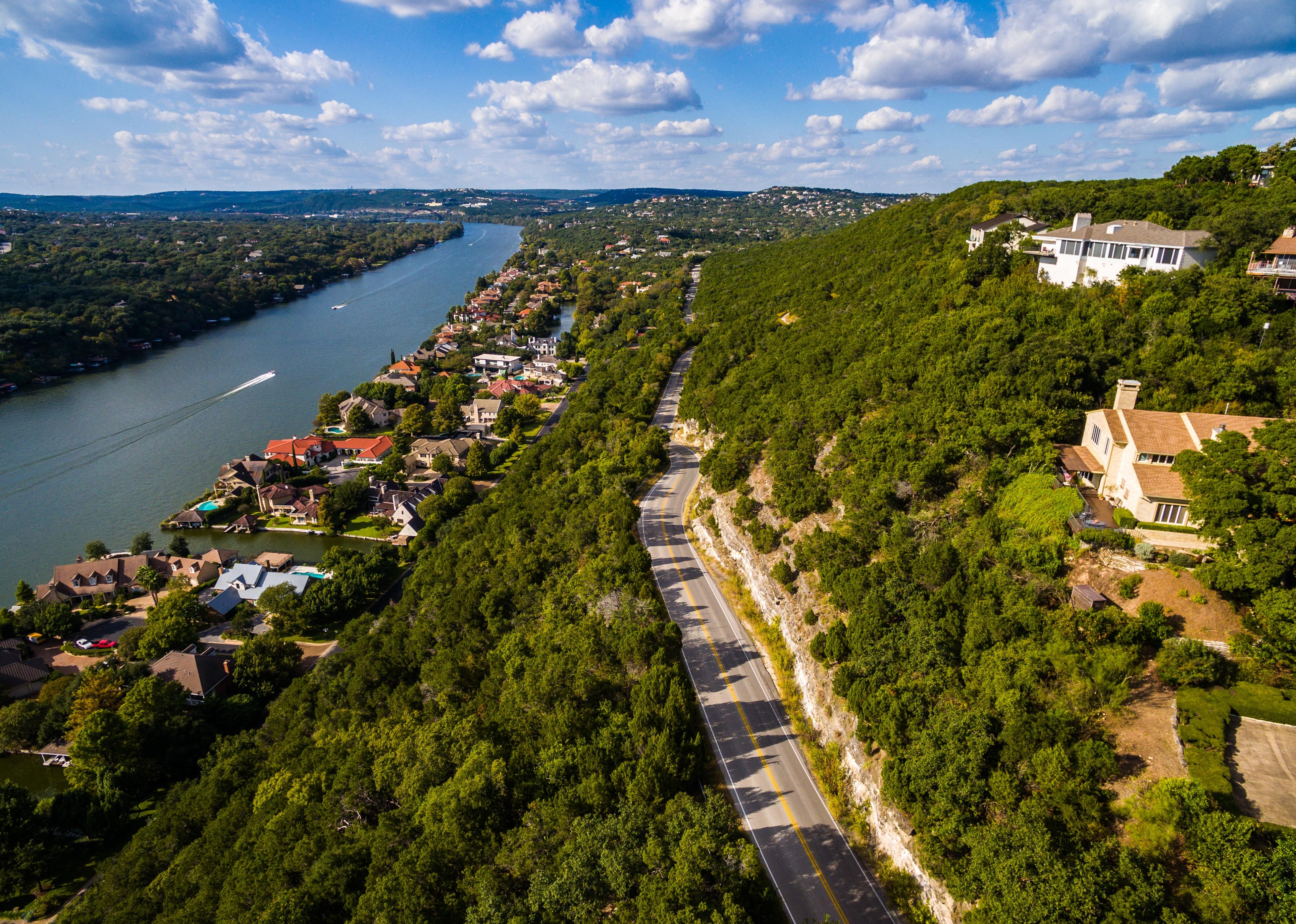 Windy road and houses along the Colorado River in Texas near Austin.