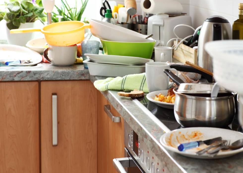 Pile of dirty dishes in a kitchen.