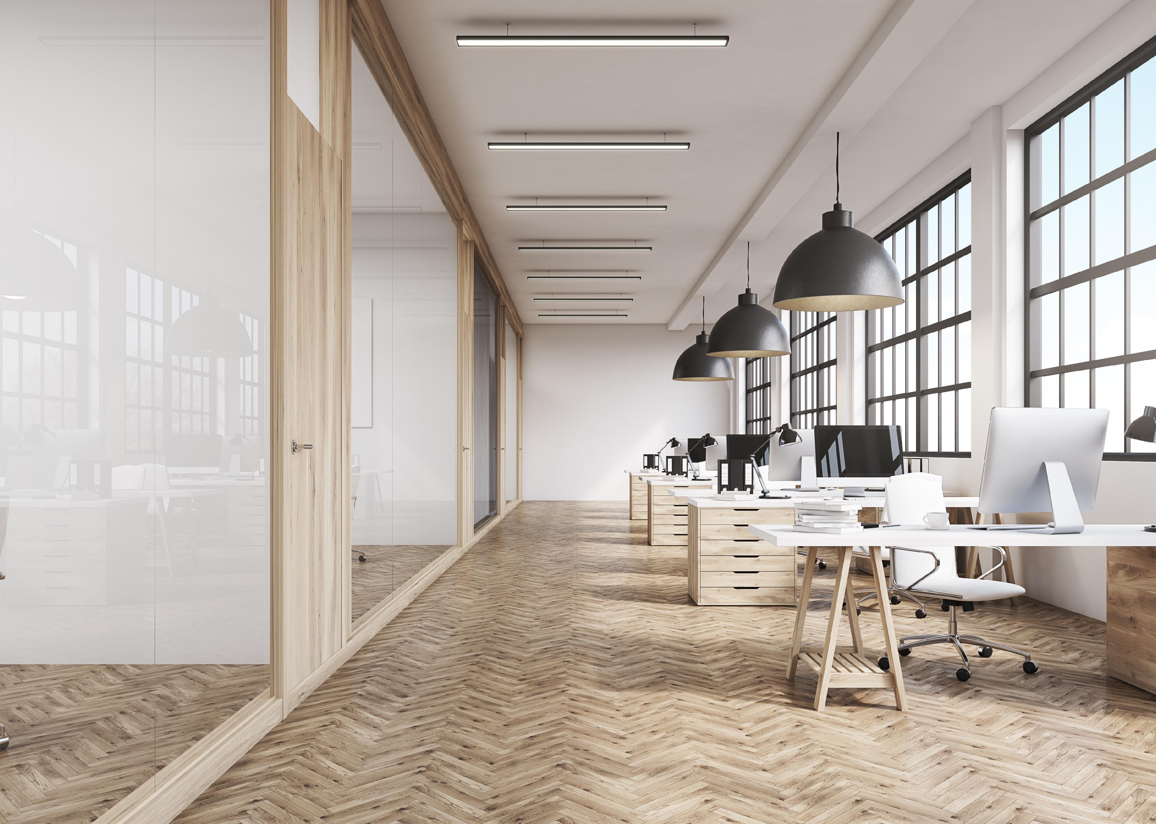 Front view of an office interior with a row of dark wood tables.