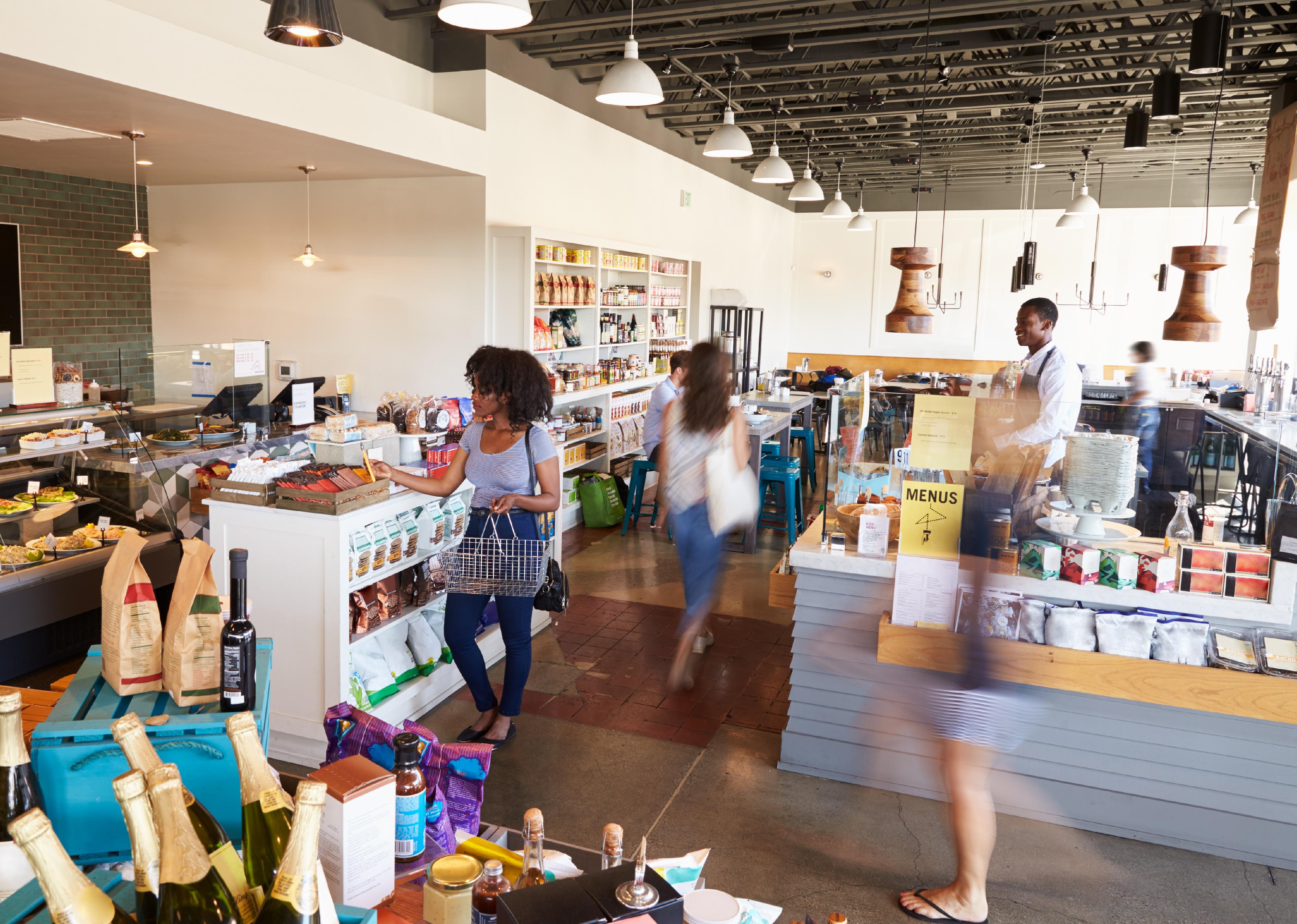 Interior of busy delicatessen with customers.