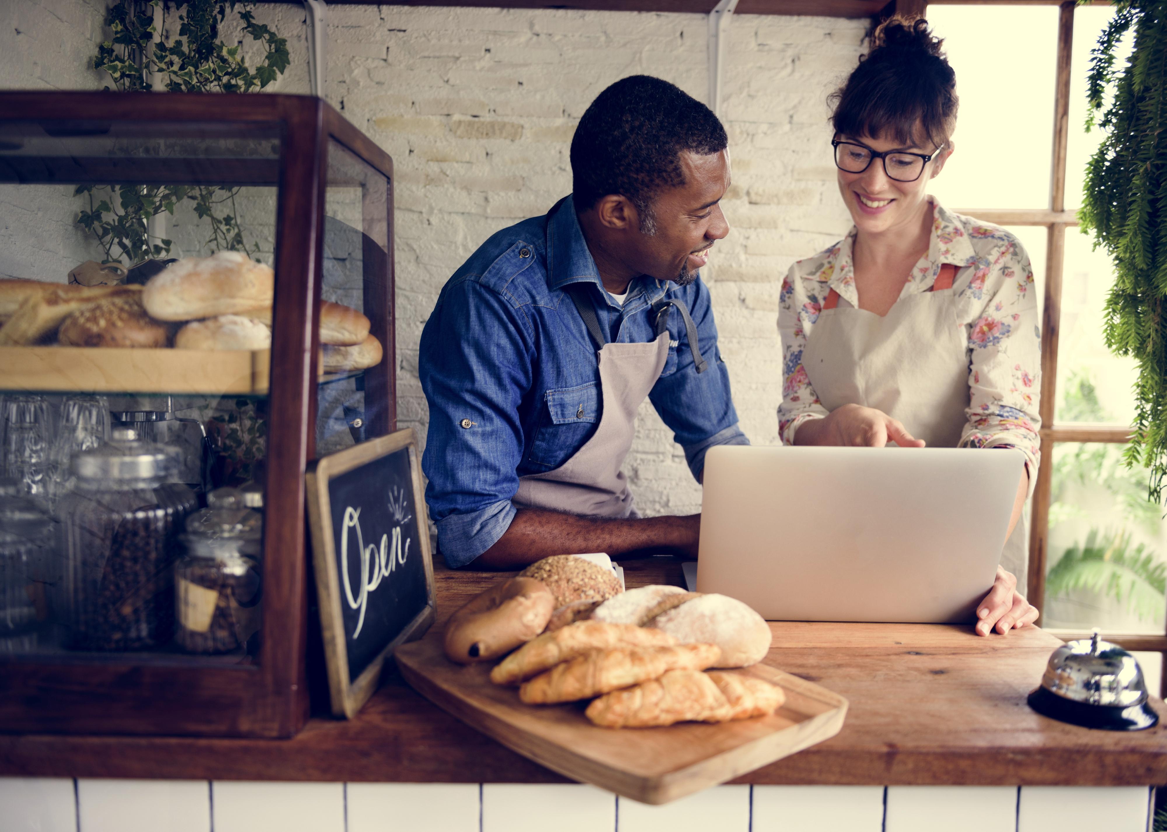 Man and woman behind a bakery counter