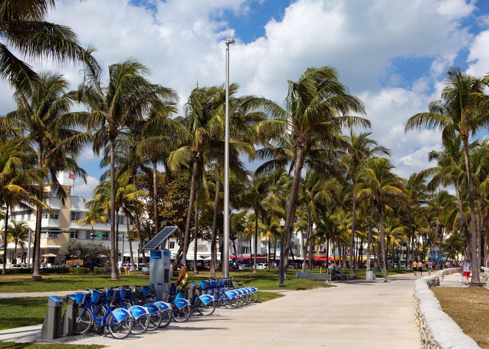 Man uses a self-service kiosk station to rent a bicycle on Ocean Drive in Miami Beach