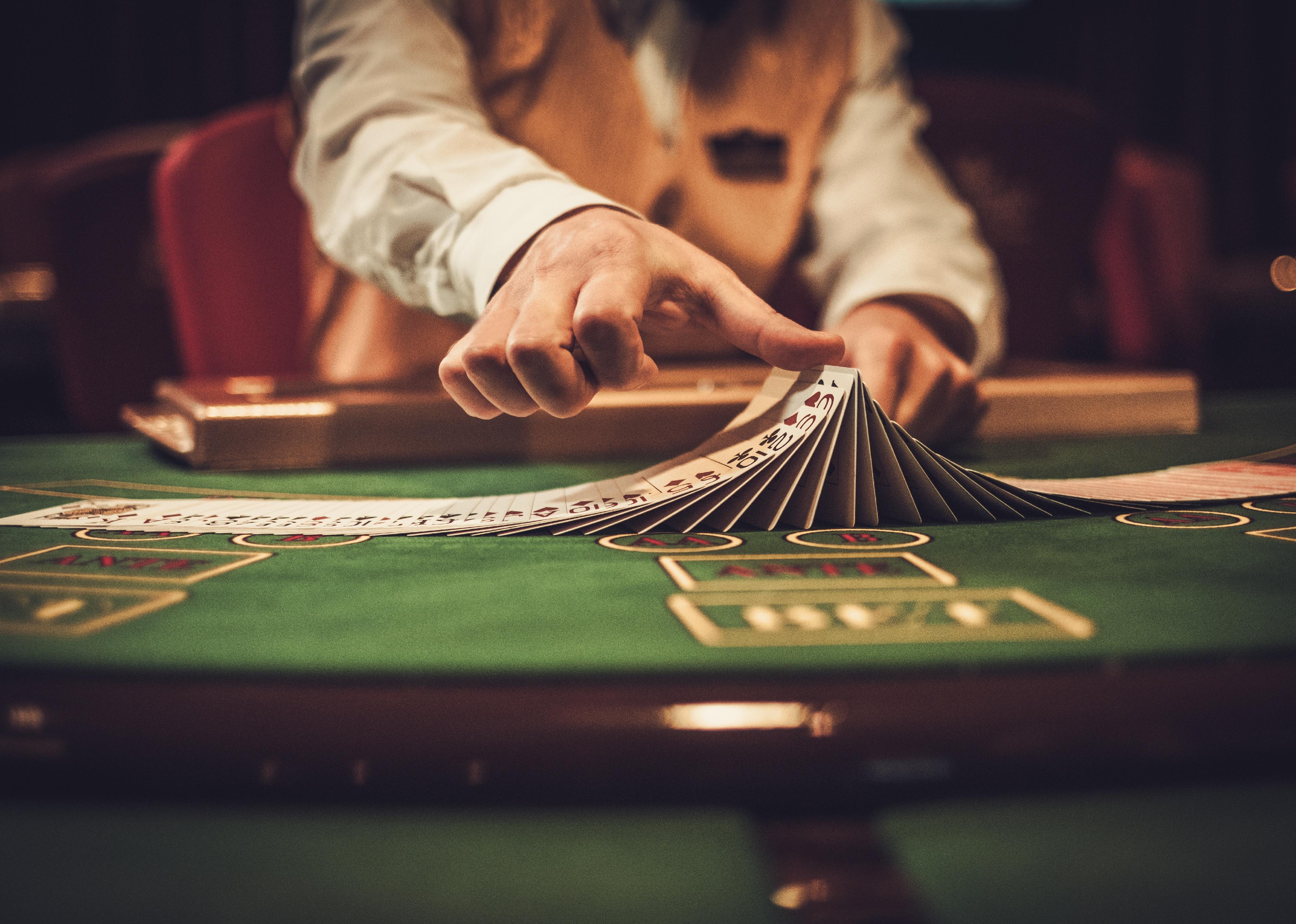 Croupier behind gambling table in a casino.