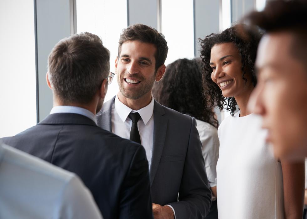 Group of business people speaking in a group.