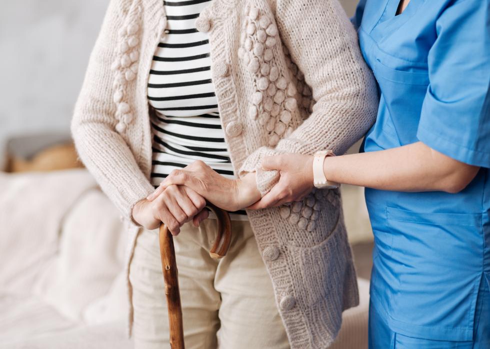 Aide helping a senior patient.