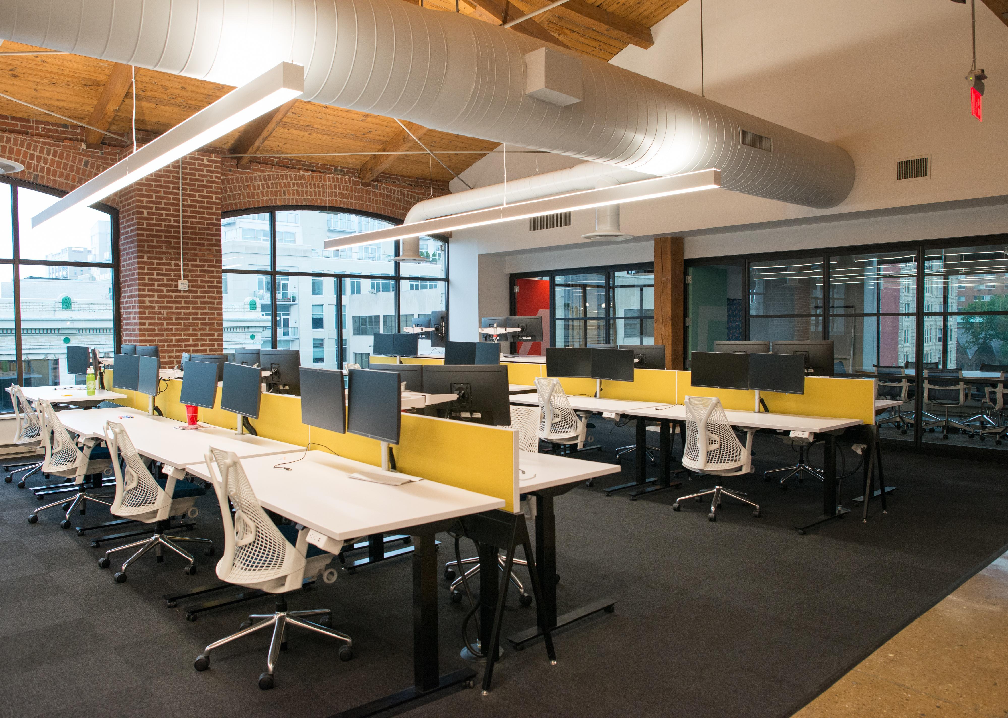Trendy modern open concept loft office space with big windows.