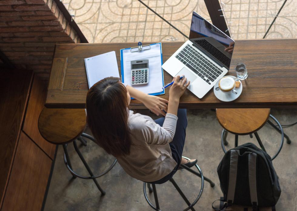 Asian woman working on laptop at cafe